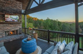 Skyfall | Cabin Rentals of Georgia | Luxury outdoor living area with fireplace and TV overlooking mountain view