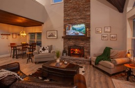 Skyfall | Cabin Rentals of Georgia | Living Room with fireplace, TV, and expansive seating 