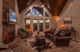 Skyfall | Cabin Rentals of Georgia | Luxury living area with window wall, mountain view, and upscale furnishings