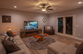 Skyfall | Cabin Rentals of Georgia | Terrace Level living area with electric fireplace, plenty of seating, TV, wet bar, and game table