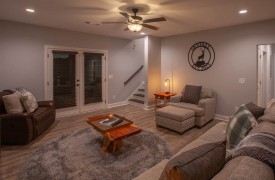 Skyfall | Cabin Rentals of Georgia | Terrace Level living area with electric fireplace, plenty of seating, TV, wet bar, and game table
