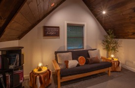 Skyfall | Cabin Rentals of Georgia | Loft with futon and bookshelf