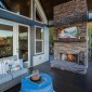 MainLevelcoveredporchwithplushsofa,wood-burningfireplace,andTV